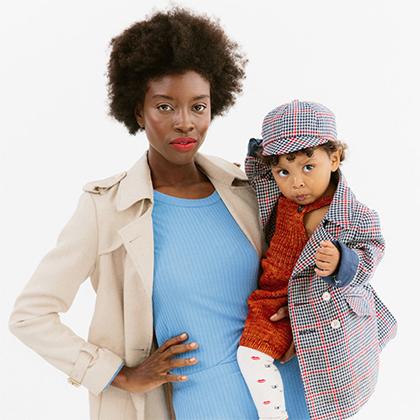 woman wearing a blue fall dress while holding toddler
